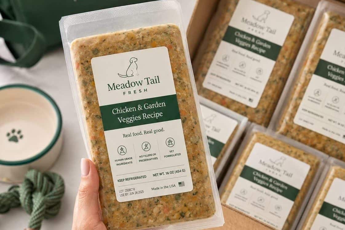 Fresh refrigerated pet food trays with printed labels showing recipe name and ingredient claims